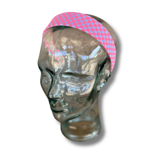 Mannequin head wearing a neon checkered headband on a white background