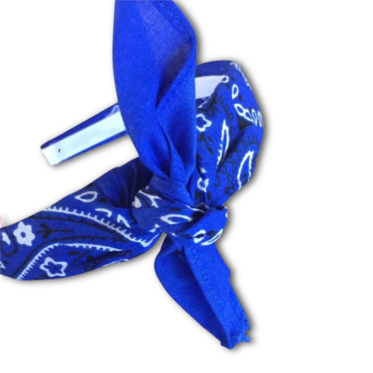 Royal Blue paisley kerchief bandana is wrapped around a plastic headband and tied in a knot. Hairband is designed to not slip