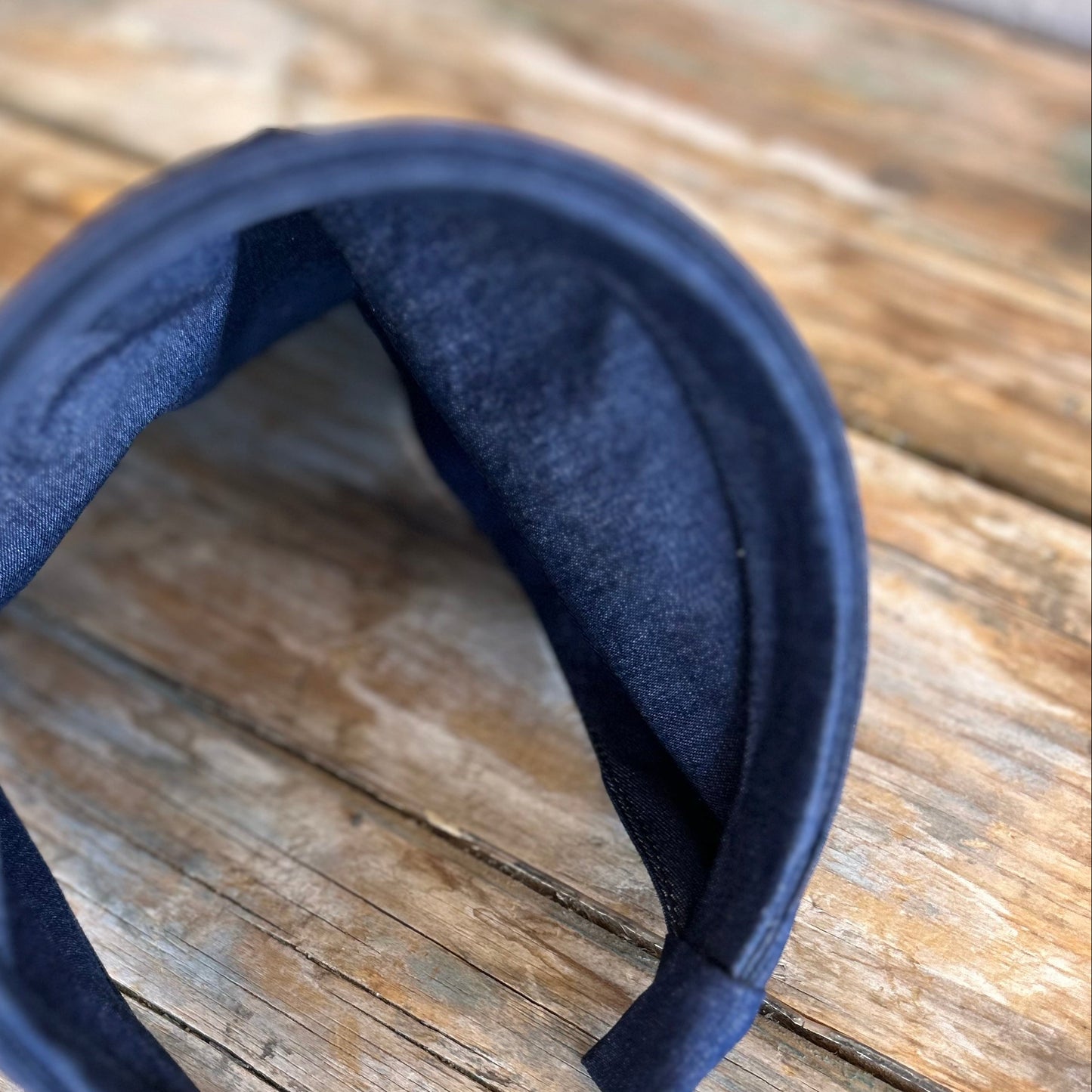 Navy blue headband on a wooden surface