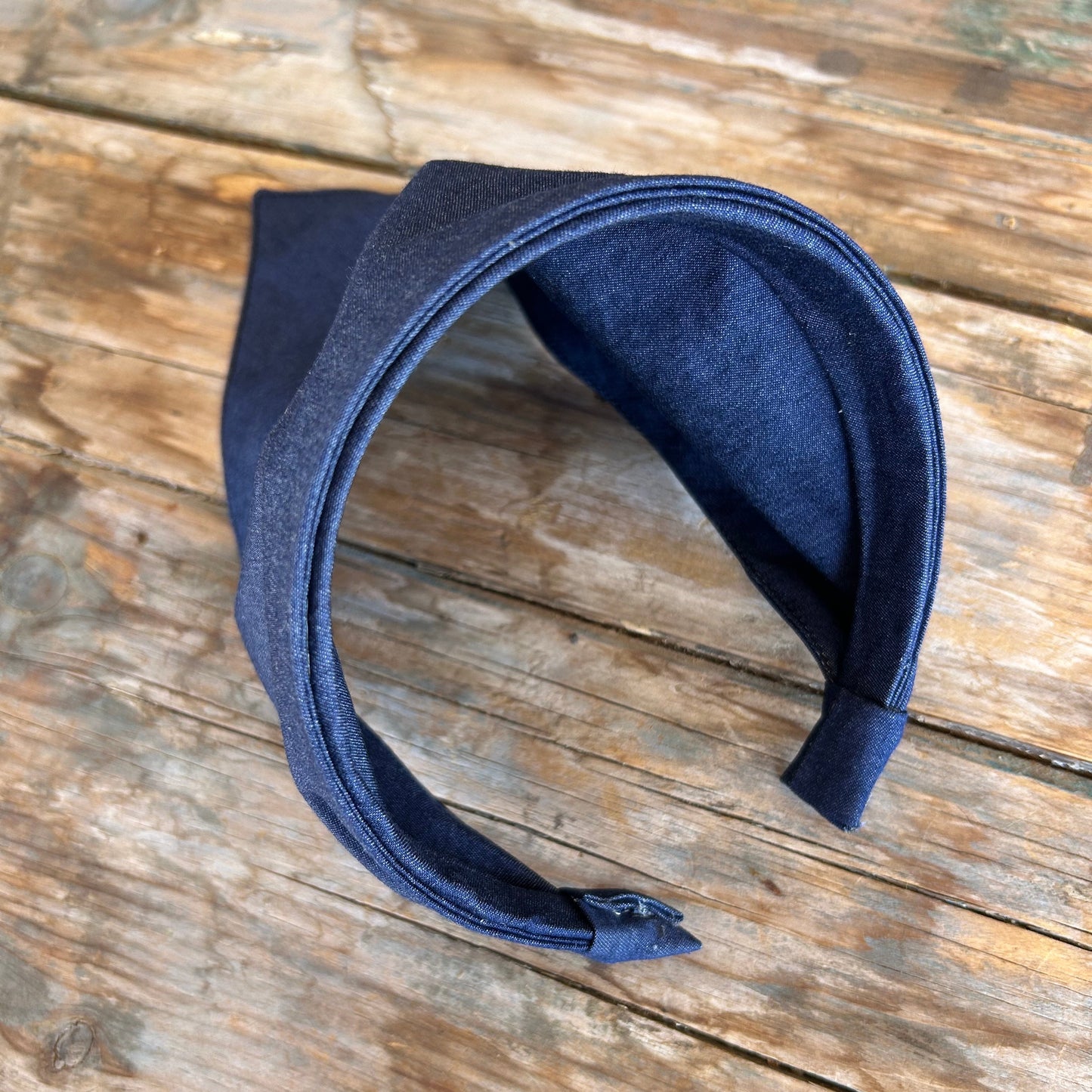 Navy blue headband on a wooden surface