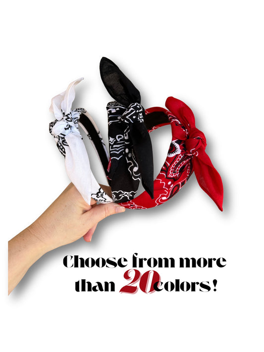 Hand holding a bundle of bandanas in various colors with text 'Choose from more than 20 colors!'.