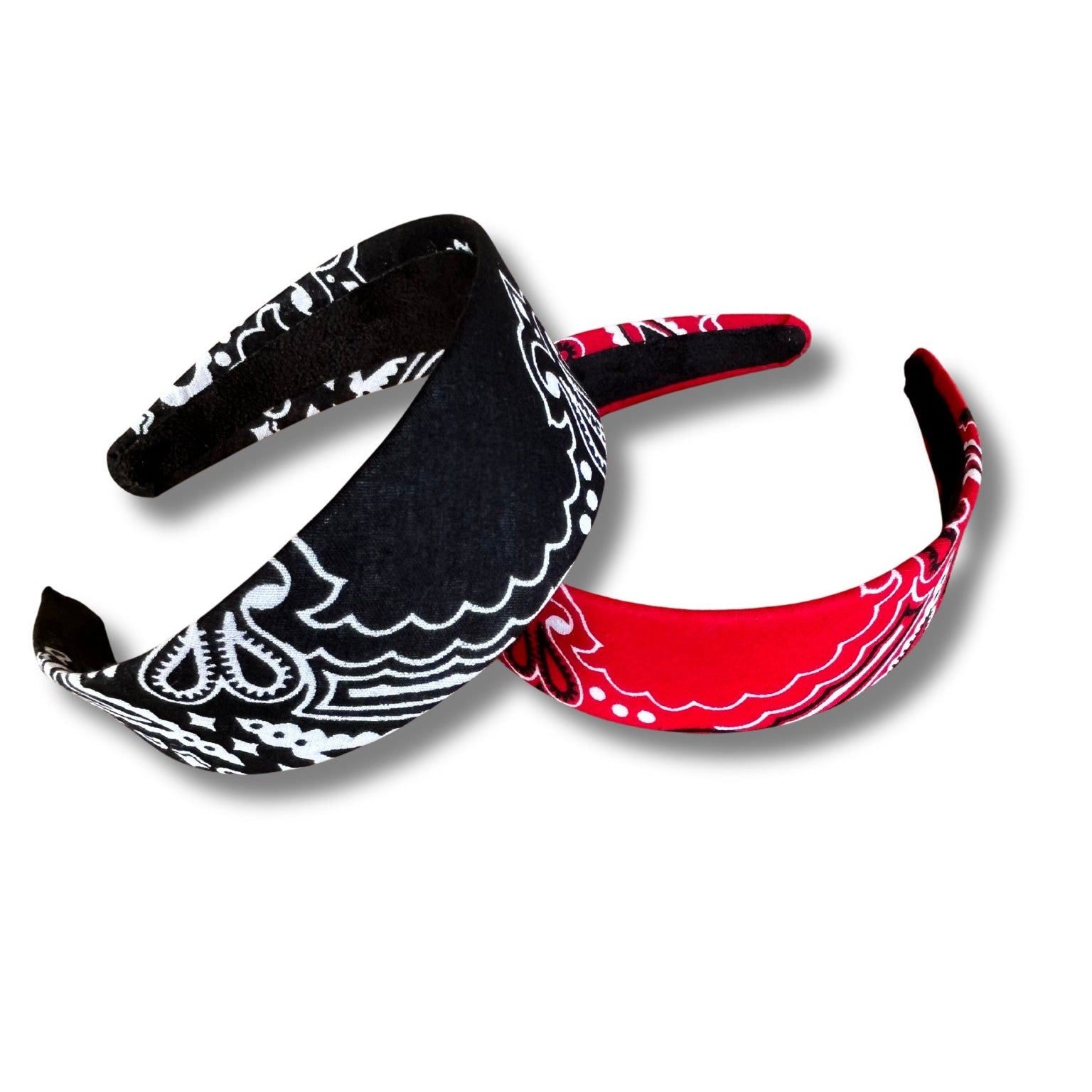 Two headbands, one black and white patterned and one red, on a white background
