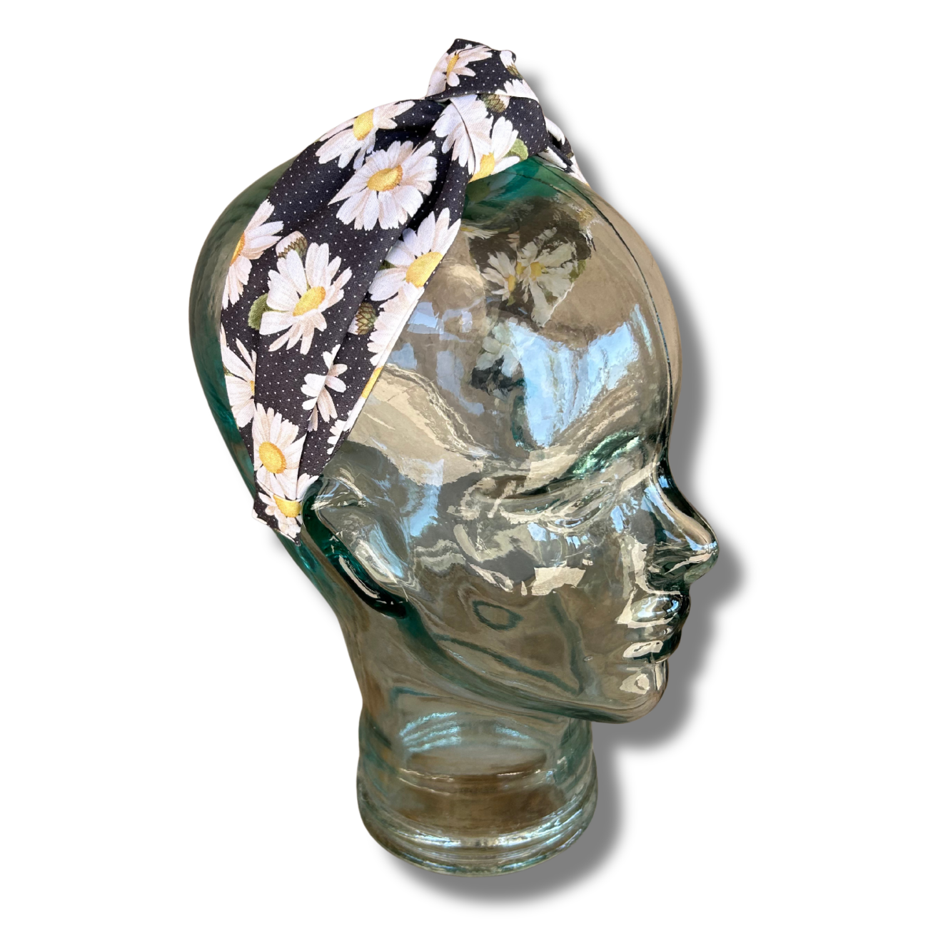 Floral headband on a glass mannequin head against a white background