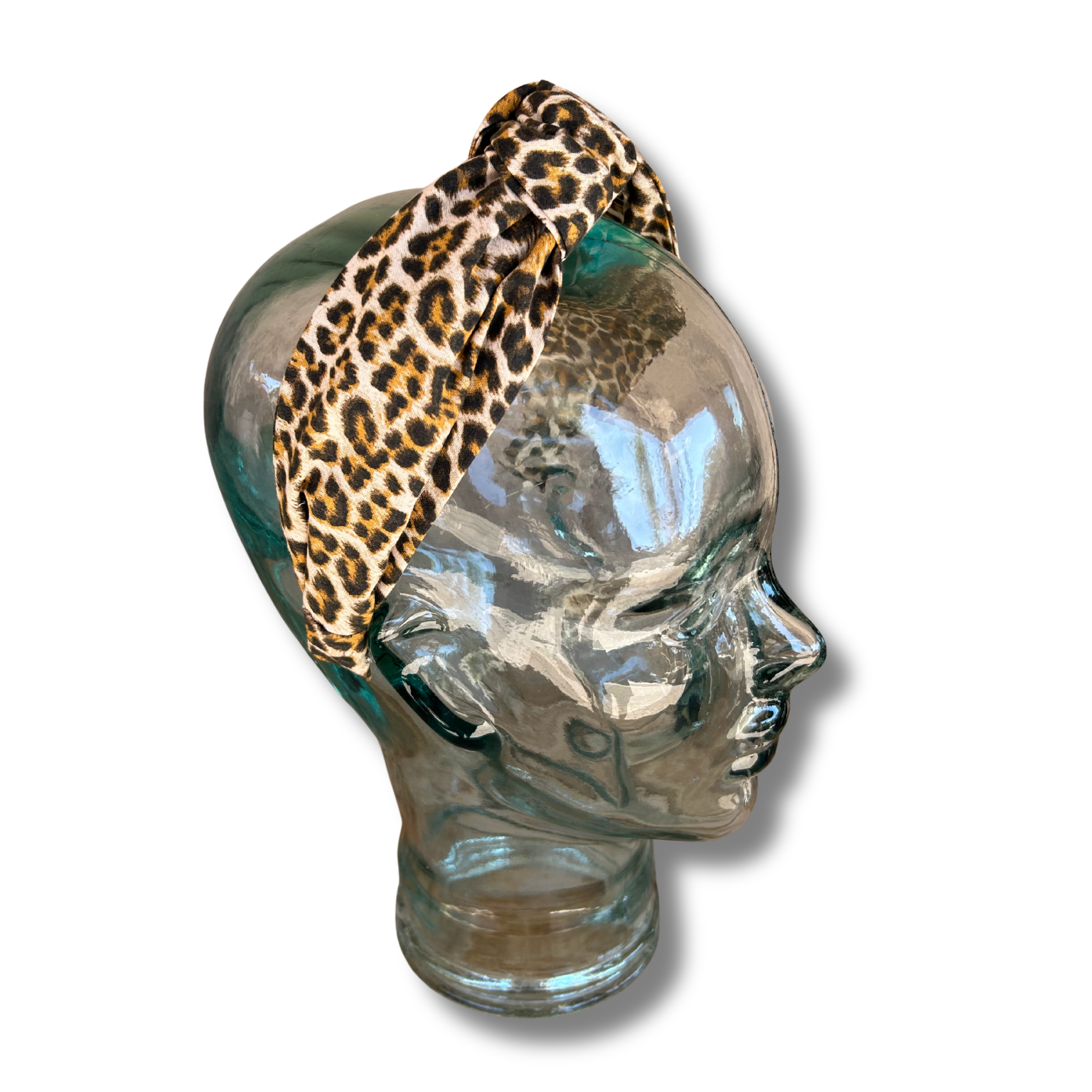 Glass head with a leopard print object on a white background