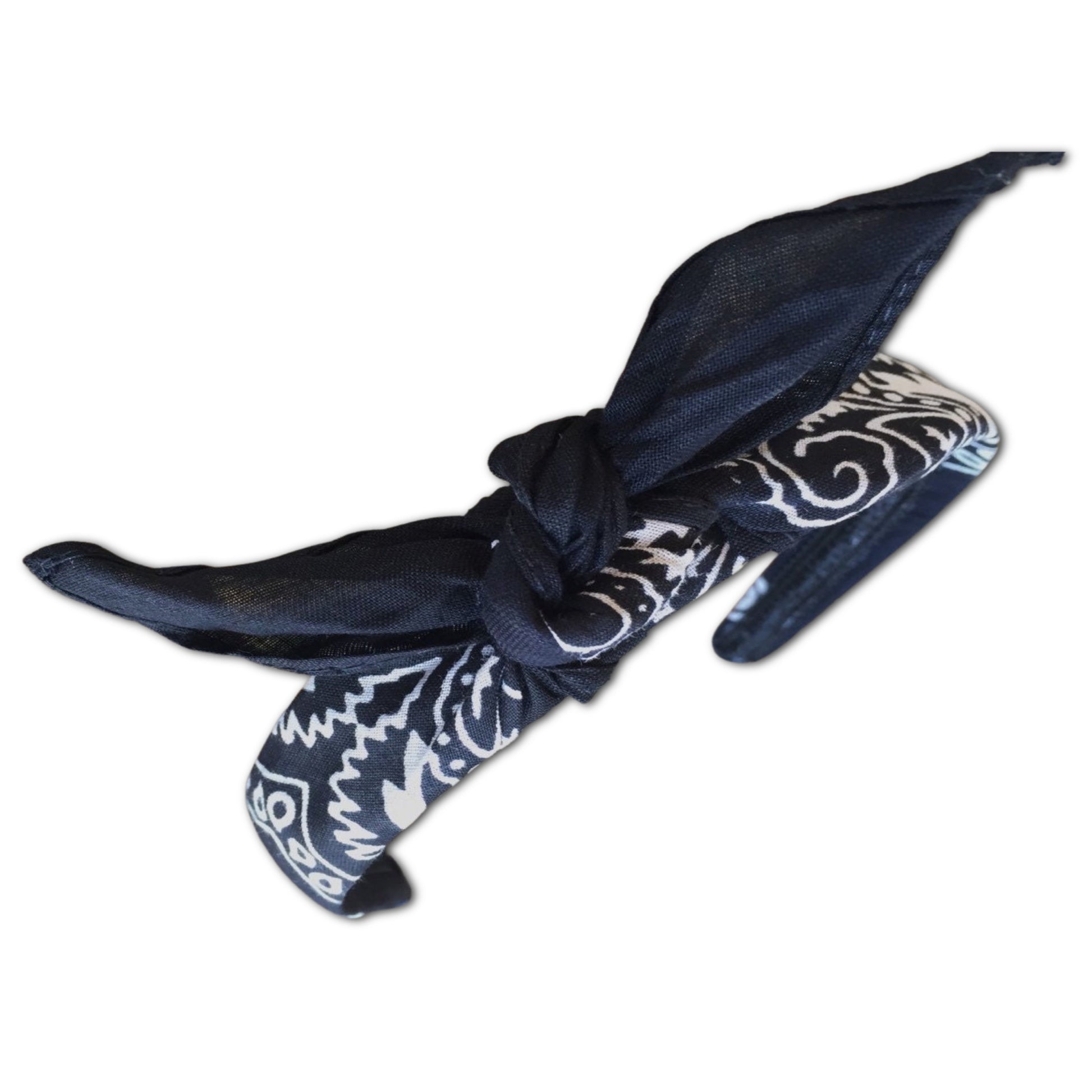 Black paisley kerchief bandana is wrapped around a plastic headband and tied in a knot. designed to not slip