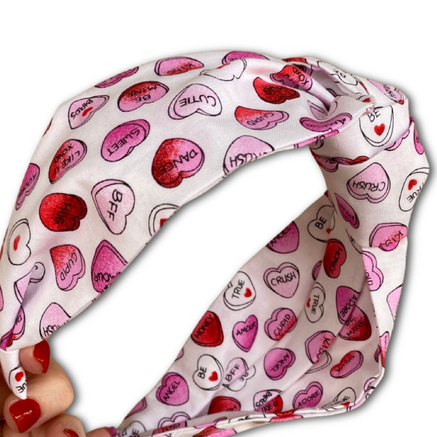 Headband that features pink and red conversation hearts throughout