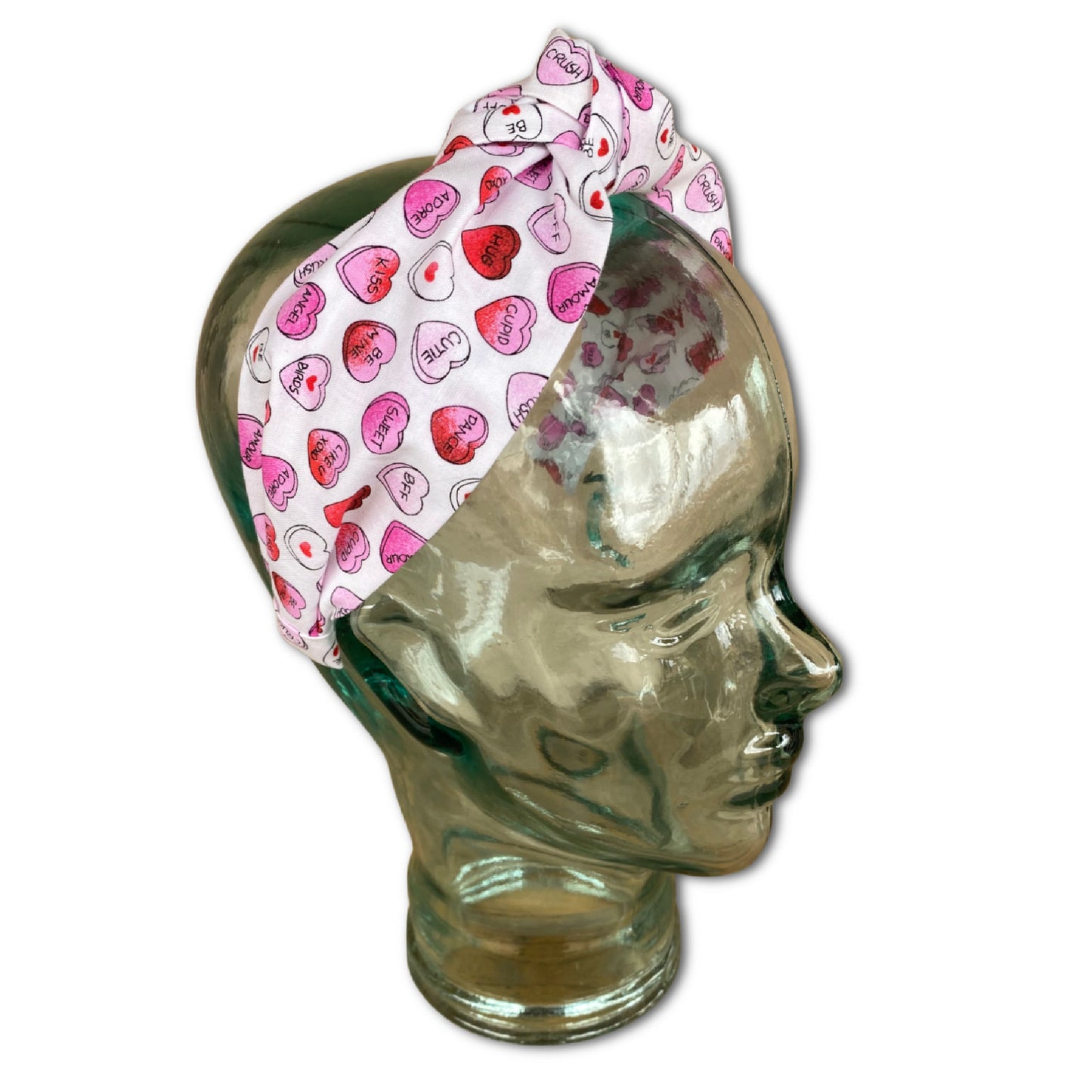 Headband that features pink and red conversation hearts throughout