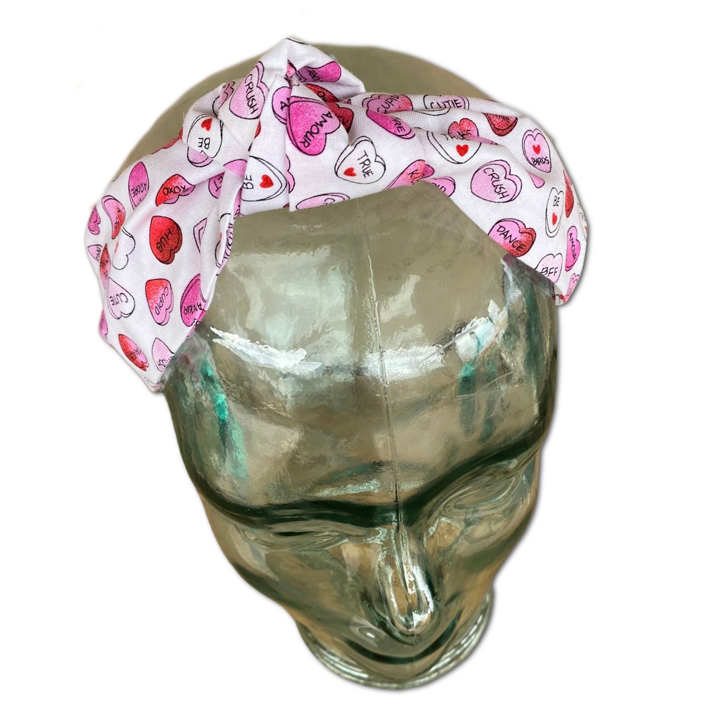 Headband that features pink and red conversation hearts throughout