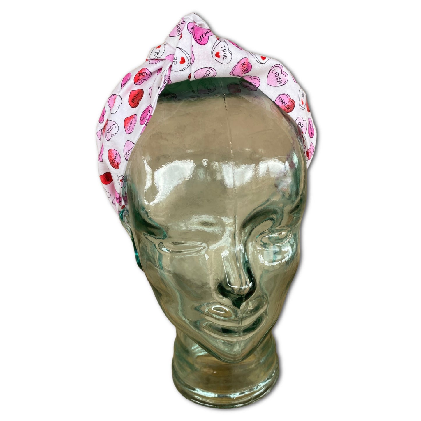 Headband that features pink and red conversation hearts throughout