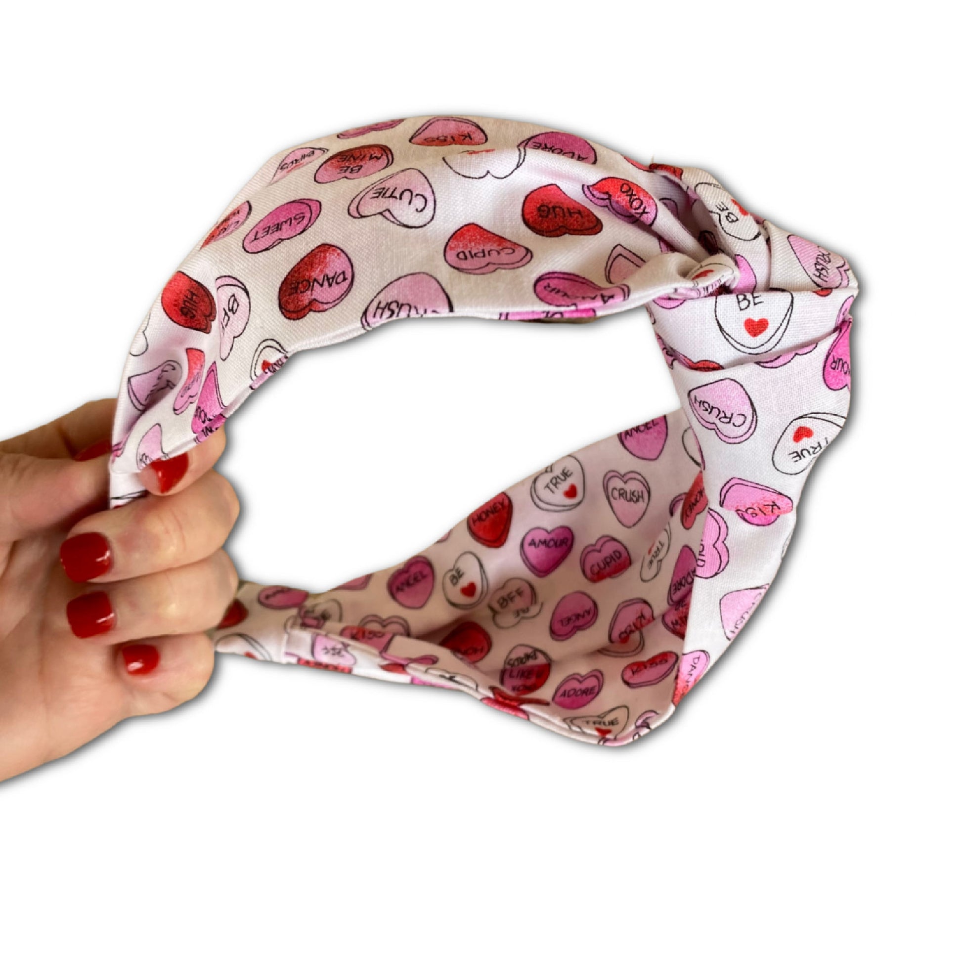Headband that features pink and red conversation hearts throughout