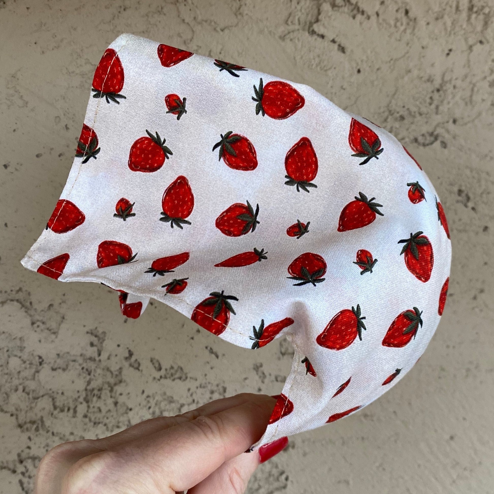 head scarf that has been attached to a headband that features a strawberry print. Beige background