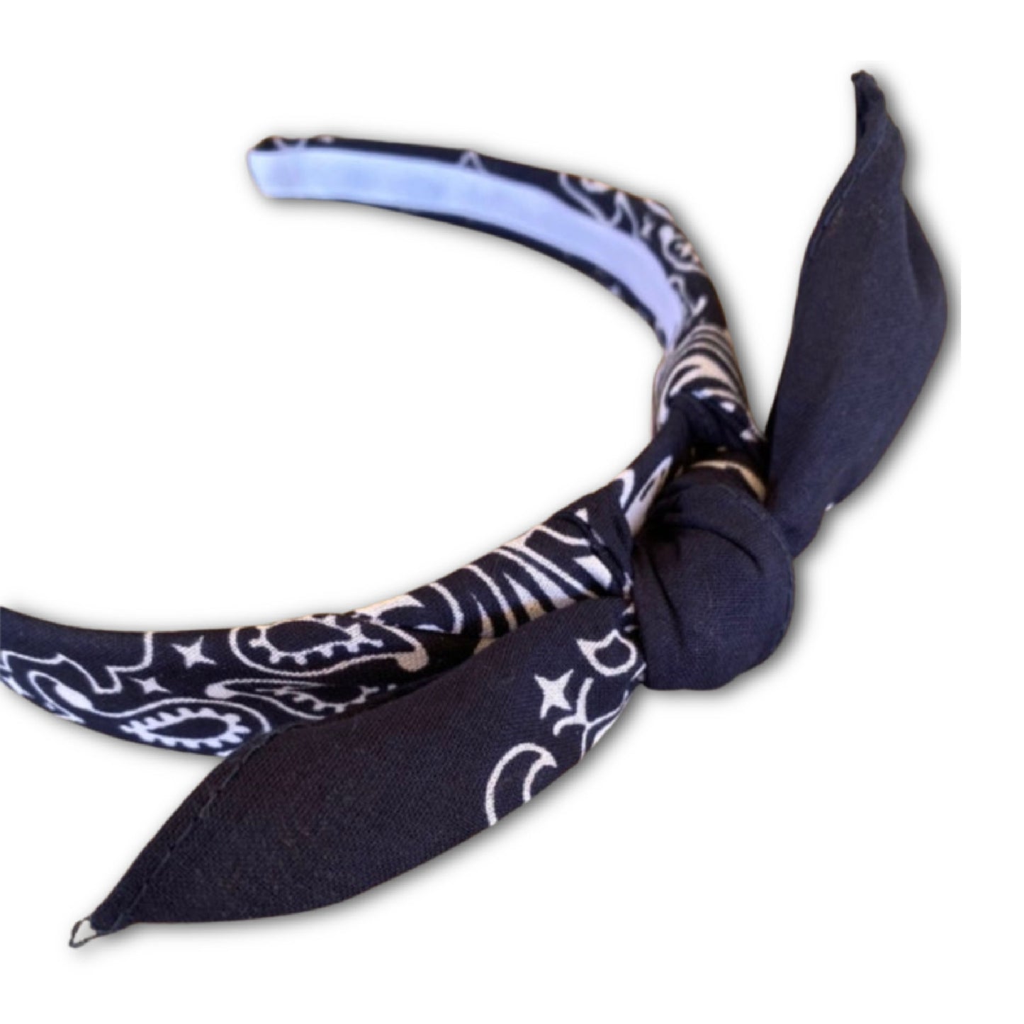 Navy Blue  paisley kerchief bandana is wrapped around a plastic headband and tied in a knot. Hairband is designed to not slip