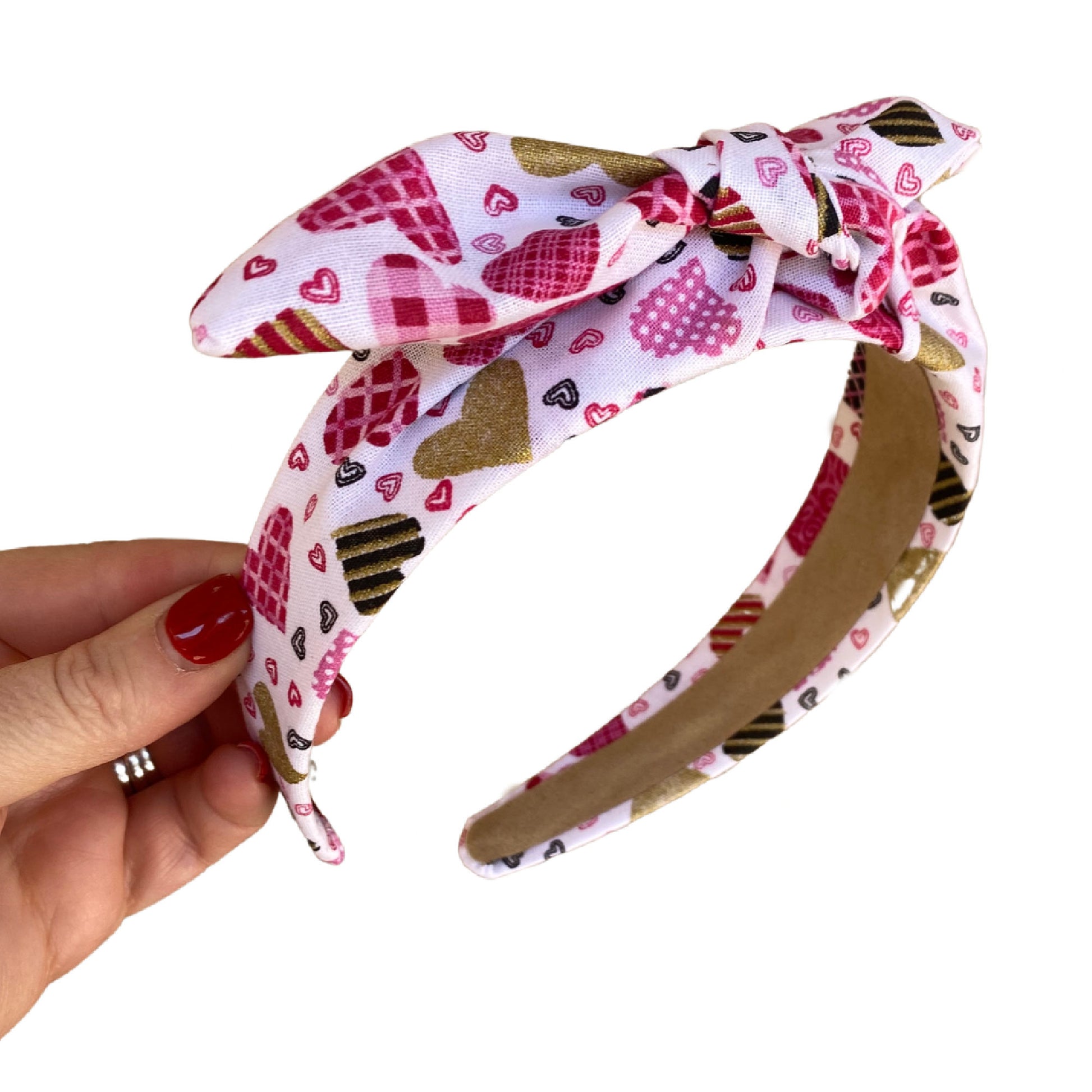 Headband that is pre tied with a tie on the top. Heart patchwork print throughout. 