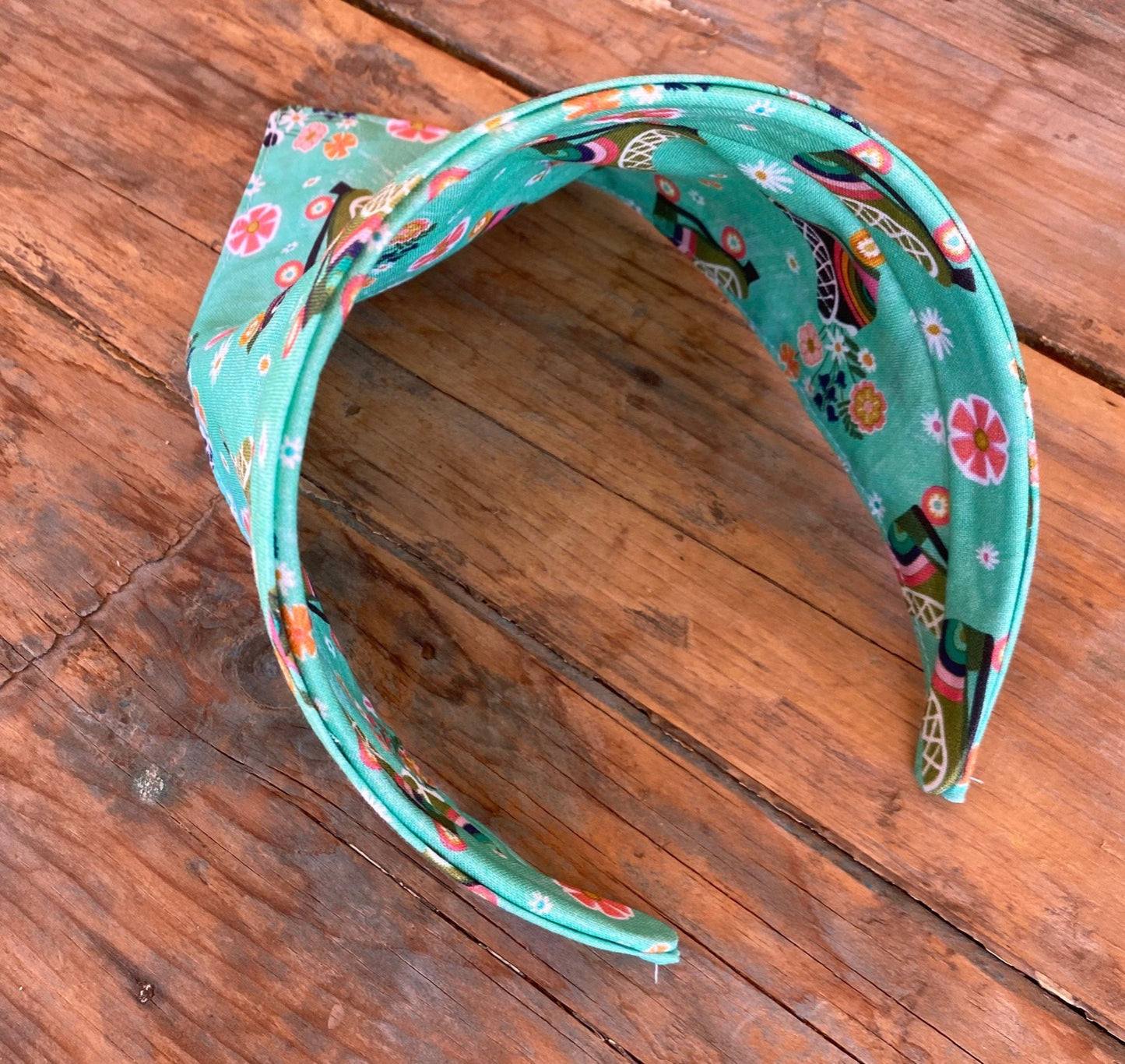 triangle head scarf attached to a headband. features a roller skating print.