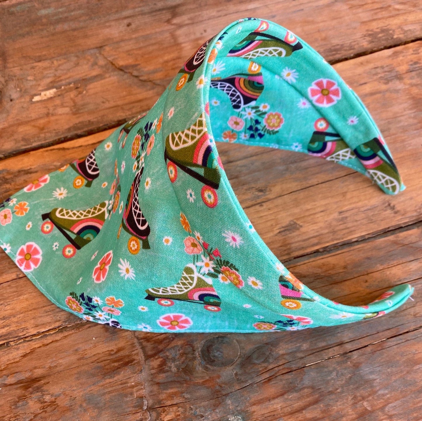 triangle head scarf attached to a headband. features a roller skating print.