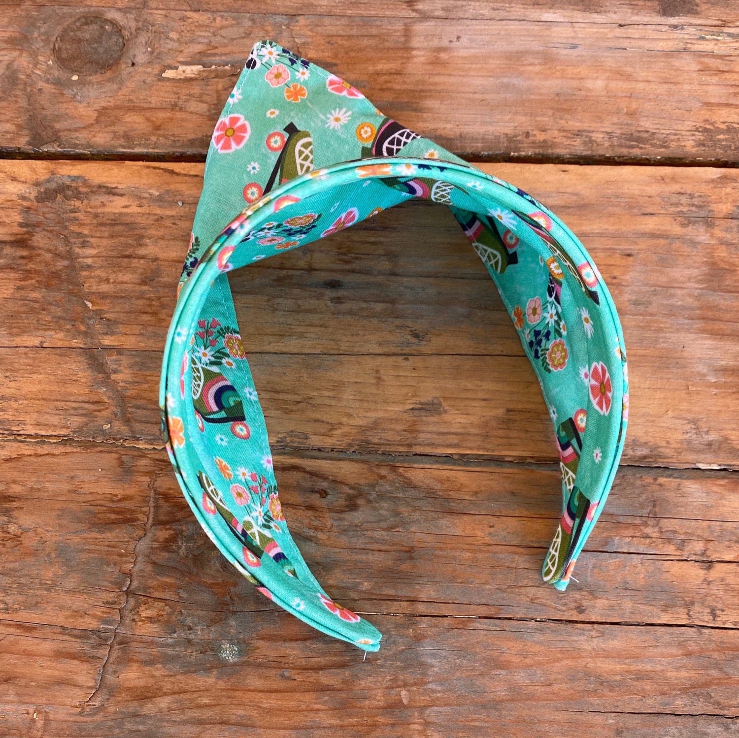 triangle head scarf attached to a headband. features a roller skating print.